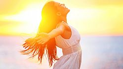 Enjoyment – free happy woman enjoying sunset